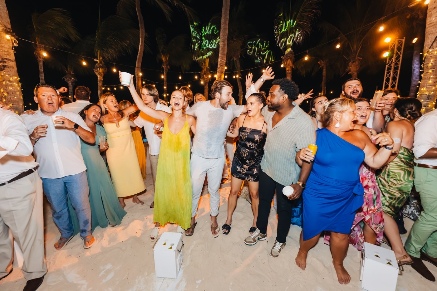 A couple and their guests celebrating together on the dance floor